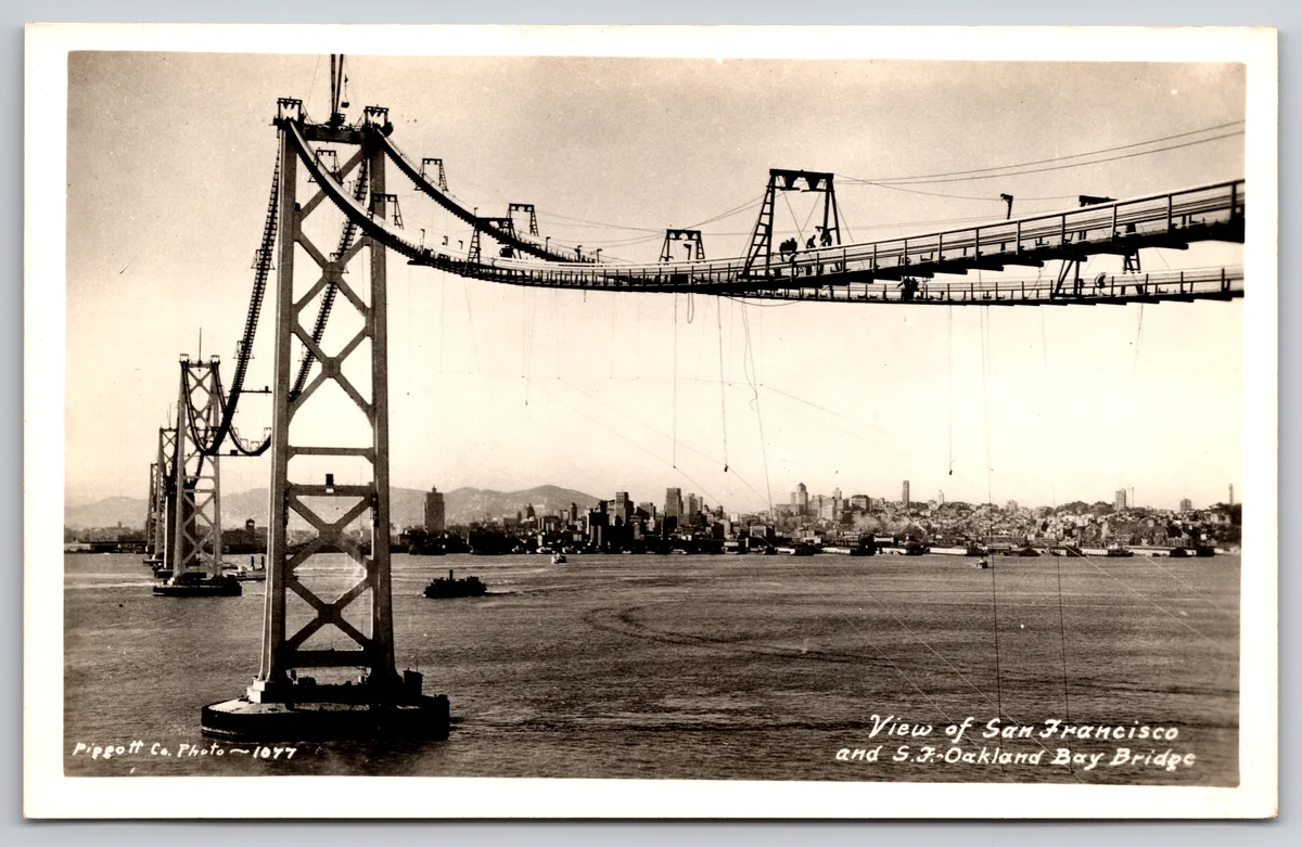 The front of a real photo postcard of the San Francisco-Oakland Bay Bridge under construction, from the Postcard Origins collection