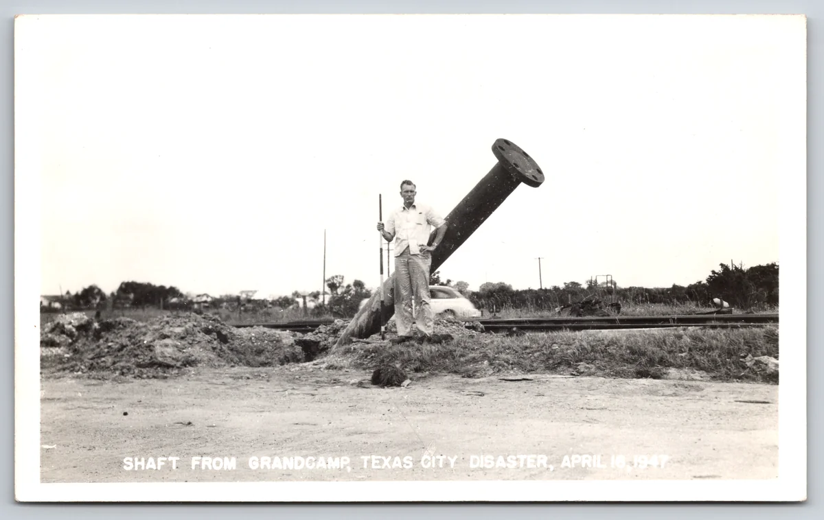 A real photo postcard of the shaft thrown from the SS Grandcamp in the 1947 Texas City Disaster, captioned on the card with the date, from the Postcard Origins collection