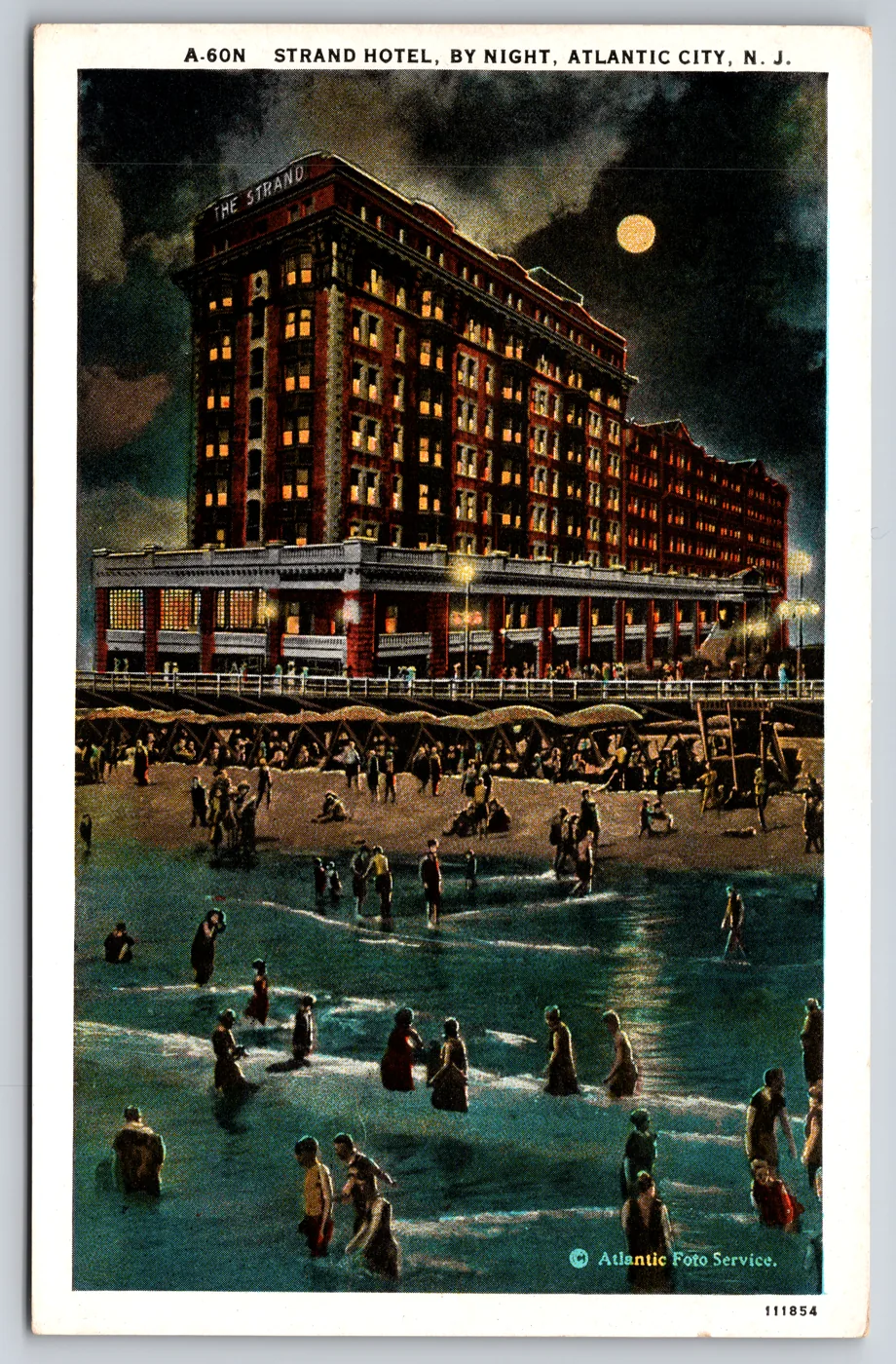 A genuine Curt Teich C.T. American Art Colored postcard from the Postcard Origins collection: Strand Hotel by night, Atlantic City, New Jersey